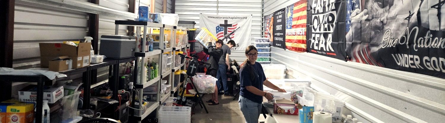 Inside the shared ministry warehouse — shelving and a packing table